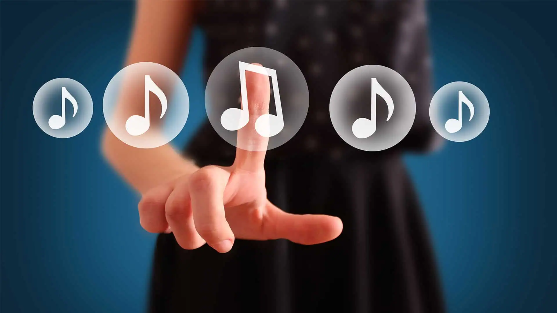 Woman in a black dress tapping one of five buttons with musical notes on them as viewed from behind the buttons
