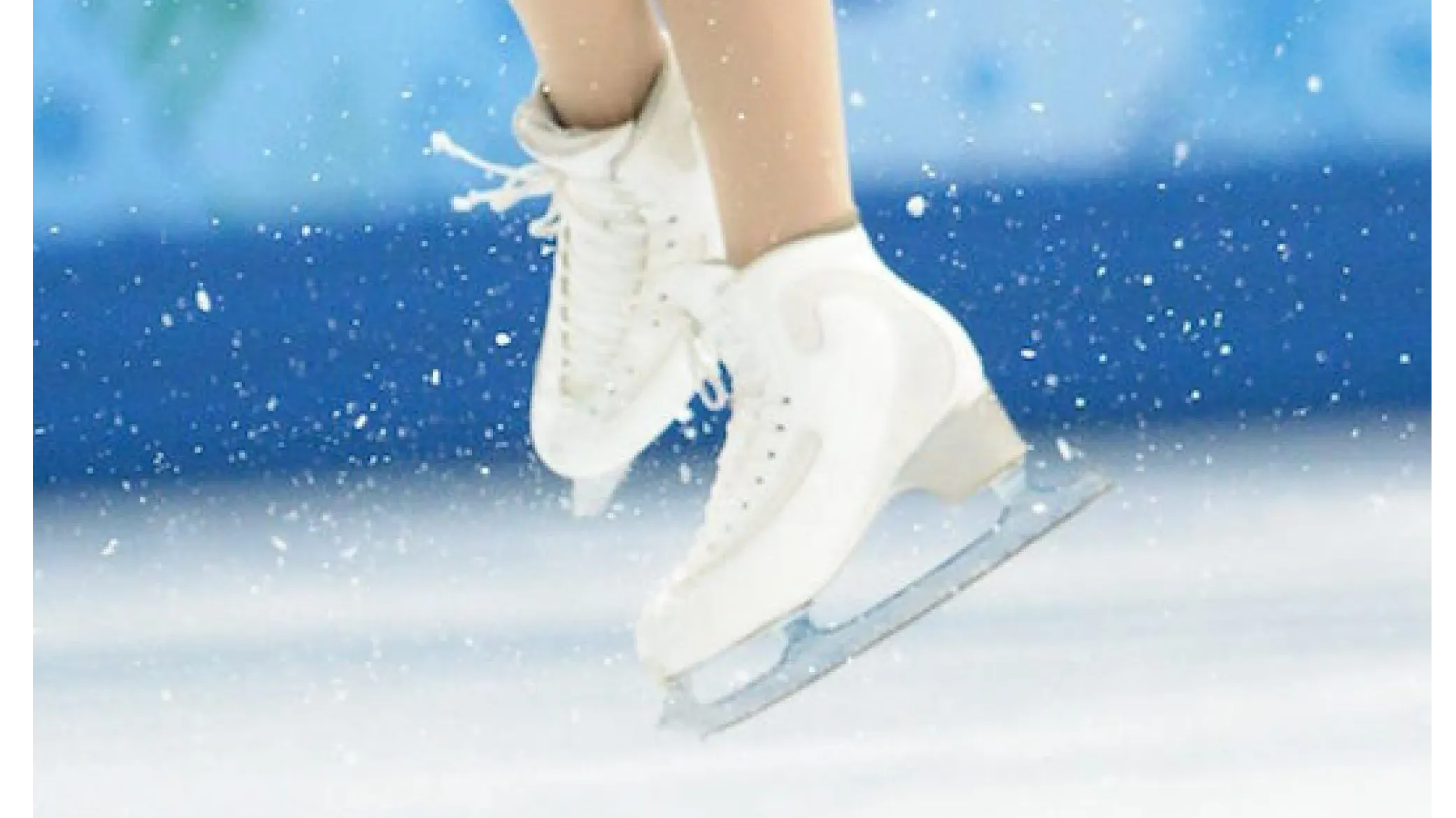 Close up of white figure skates crossed over each other in the middle of a jump